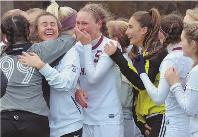  ?? STAFF PHOTO BY CHRIS CHRISTO ?? MOHAWK MAGIC: Millis players (above) celebrate after their 1-0 win against Millbury in the Div. 4 girls state final yesterday in Worcester. Below, Millbury’s Kelsey Turner (10) gets tripped up as she battles with Millis’ Julia Krauss for the ball.