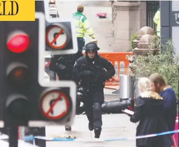  ?? ROBERT PERRY / AFP VIA GETTY IMAGES ?? Police respond at the scene of a knife rampage at the Park Inn Hotel in central Glasgow, Scotland on Friday. Armed officers shot dead an asylum seeker from Sudan suspected of injuring six people in the stabbing spree.