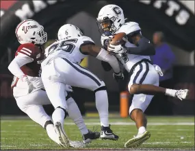  ?? Jessica Hill / Associated Press ?? UConn defensive back Oneil Robinson (17) intercepts a pass intended for UMass wide receiver Jermaine Johnson Jr. as defensive back Tyler Coyle (25) defends on Saturday.