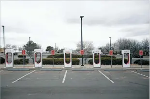  ?? LUIS SÁNCHEZ SATURNO/THE NEW MEXICAN ?? A Tesla charging station at Fashion Outlets of Santa Fe can accommodat­e several vehicles. But they only make up about 600 of the 2.46 million registered in the state.