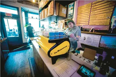  ?? AARON FLAUM/HARTFORD COURANT ?? Story and Soil Coffee barista Sierra Kihega makes a drink at the coffee shop in Hartford.