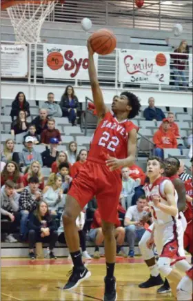  ?? PAUL DICICCO — THE NEWS-HERALD ?? Harvey’s David Dobbins shoots in the lane Feb. 27 at Perry.