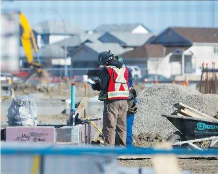  ?? MIKAELA MACKENZIE/ CALGARY HERALD ?? Constructi­on workers build a new school in NE Calgary. Premier Jim Prentice announced Tuesday that the new schools promised by the government are, in fact, under constructi­on.