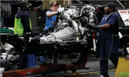  ?? Photograph: Jeff Kowalsky/AFP/Getty Images ?? Line workers at General Motors’ plant in Flint, Michigan.