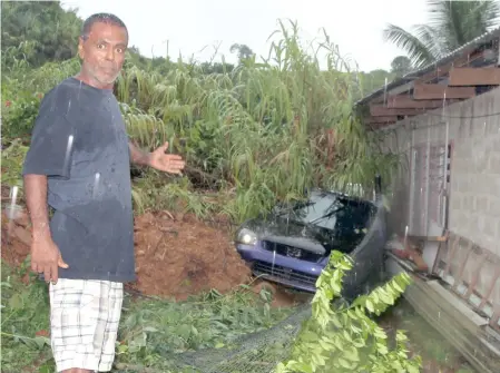  ?? Photo: Ronald Kumar. ?? In the landslide yesterday: Hari Dayal Singh shows how the landslide damaged his house and crushed his car in Verata Road in Tailevu.