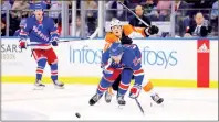  ?? PHOTO: BRAD PENNER-USA TODAY ?? The New York Rangers’ Adam Fox, front, reacts after being hit in the face by the Philadelph­ia Flyers’ Tyson Foerster, center back, at Madison Square Garden in New York on Tuesday.