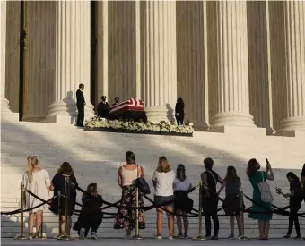  ?? Ap photos ?? HONORING A ‘ROCK STAR’: People, including Vice President Mike Pence and his wife Karen Pence, at right, pay their respects as Justice Ruth Bader Ginsburg lies in repose under the Portico at the top of the front steps of the U.S. Supreme Court building in Washington, Wednesday. Ginsburg, 87, died of cancer on Friday.