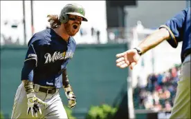  ?? LOGAN RIELY / GETTY IMAGES ?? Ben Gamel of the Milwaukee Brewers celebrates after hitting the game-winning home run in the 10th inning Sunday off Braves reliever Wes Parsons.