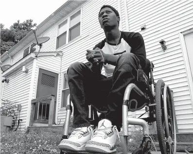  ?? AP Photo/Allen G. Breed ?? n Rayquan Briscoe sits outside his home July 25 in Wilmington, Del.