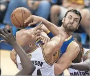 ?? Ron Schwane Associated Press ?? GOLDEN STATE’S Andrew Bogut, right, tangles with Richard Jefferson as they fight for a loose ball.