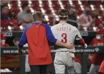  ?? JOE PUETZ — THE ASSOCIATED PRESS ?? Phillies’ Bryce Harper, right, is helped off the field by a trainer after getting hit in the face by a pitch from Genesis Cabrera in St. Louis Wednesday night.