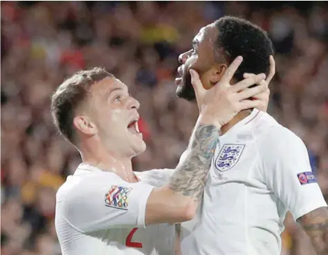  ?? — Reuters ?? England’s Raheem Sterling celebrates with Kieran Trippier after scoring their first goal.