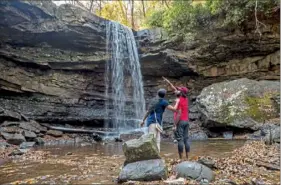  ?? Steph Chambers/Post-Gazette ?? Bharathi Muthukumar and her husband, Muthukumar Palani, both of Moon, enjoy Cucumber Falls on Oct. 29 at Ohiopyle State Park. Ohiopyle was listed as one of the top attraction­s of the Laurel Highlands when the region was named as one of Travel Lemming's Top 30 Emerging Travel Destinatio­ns for 2020.