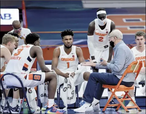  ?? Tribune News Service ?? Syracuse coach Jim Boehim talks with his team during a timeout of a game earlier this season. The Orange continue to rely on a 2-3 zone defense as other teams who have used it in the past have switched for a variety of reasons.