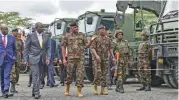  ?? (AFP) ?? Kenya’s President, William Ruto (second from left) inspect fleet of vehicles to be used by KDF soldiers being deployed to DRC