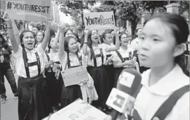  ?? Francis R. Malasig European Pressphoto Agency ?? STUDENTS from St. Scholastic­a’s College, above, and members of a coalition called Millennial­s Against Dictators plan to keep pressuring the government.