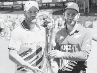  ??  ?? Australia and New Zealand captains, Aaron Finch, left and Kane Williamson with the trophy at stake in the T20 series.