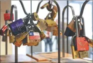  ?? JACQUES DEMARTHON / AP ?? Padlocks locked and left by couples as a symbol of love on Parisian bridges are displayed during an auction in Paris on Wednesday.