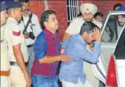  ?? KESHAV SINGH/HT ?? Vikas Barala (in blue shirt) being taken into custody.