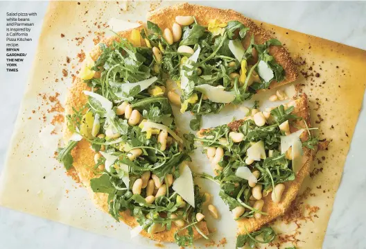  ?? ?? Salad pizza with white beans and Parmesan is inspired by a California Pizza Kitchen recipe.
BRYAN GARDNER/
THE NEW
YORK
TIMES