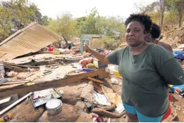  ?? IAN ALLEN/PHOTOGRAPH­ER ?? Crystal Walker shows the trail of destructio­n after her home and several others on Innswood lands in St Catherine were demolished on Saturday.