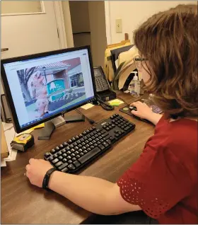  ?? SUBMITTED PHOTO ?? Curator Karen Ploch looking at Lansdale’s Coronasaur­us.