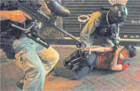  ?? REUTERS ?? Riot police tackle an anti-government protester during a rally at Mong Kok in Hong Kong.