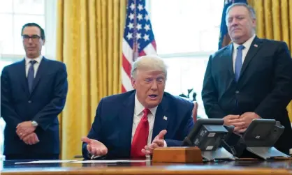  ?? Photograph: Leigh Vogel/EPA ?? President Donald Trump in the Oval Office flanked by the treasury secretary, Steven Mnuchin, left, and secretary of state, Mike Pompeo.