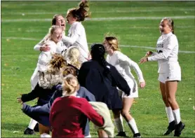  ?? PILOT PHOTO/RON HARAMIA ?? Let the celebratio­n begin! Argos’ team rushes the field after Emma Dunlap’s regional-winning shootout goal.