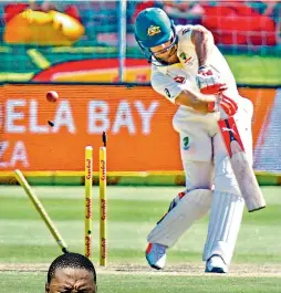  ?? — AFP ?? Mitchell Marsh is cleaned up by Kagiso Rabada.