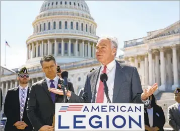  ?? J. SCOTT APPLEWHITE AP ?? Sen. Tim Kaine, D-Va., speaks alongside Sen. Todd Young, R-Ind., and representa­tives of the American Legion about ending the authorizat­ion for use of military force in the Iraq and Gulf wars Thursday.