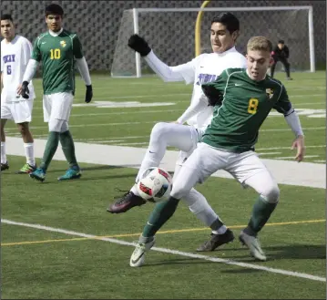  ?? MIKE BUSH/NEWS-SENTINEL ?? Tokay defender Jason Murgia battles Tracy's Toby Webb (8) for the ball, while Tokay's Edson Valle (6) and Tracy's Israel Olivares (10) watch in Tuesday's TCAL boys soccer game at the Grape Bowl.