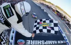  ?? JONATHAN FERREY/GETTY IMAGES ?? Kyle Busch, driver of the No. 18 M&M’s Caramel Toyota, takes the checkered flag to win the NASCAR Cup Series ISM Connect 300.