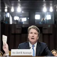  ?? AP/ANDREW HARNIK ?? Supreme Court nominee Brett Kavanaugh waves a well-worn copy of the U.S. Constituti­on as he testifies Wednesday before the Senate Judiciary Committee.