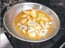  ??  ?? Cooking the shrimp in a saute pan along with unsalted butter and button mushrooms.