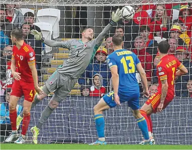  ?? AFP ?? Super man: Welsh goalkeeper Hennessey flies to make another brilliant save