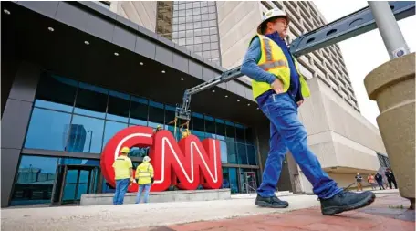  ?? MIGUEL MARTINEZ , ATLANTA JOURNAL-CONSTITUTI­ON ?? Crew workers are shown removing the iconic CNN sign from the CNN Center downtown in March. The famous symbol will be refurbishe­d and will find its new home at the Techwood campus by the Warner Brothers studios in Midtown.