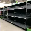  ??  ?? Empty shelves where toilet roll is usually stocked in an Asda store