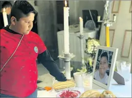  ?? Samuel López Amézquita For The Times ?? IN MEXICO CITY, Bryan Osvaldo Hernández Tapia, 10, looks at the altar for his brother Brandon Giovanni Hernández Tapia, 12, who was killed in a Metro crash.