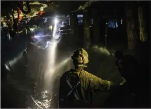  ?? (Waldo Swiegers/Bloomberg News) ?? Lights from safety helmets illuminate a mine shaft during a media tour of the Sibanye-Stillwater Khuseleka platinum mine, operated by Sibanye Gold Ltd., outside Rustenburg, South Africa.