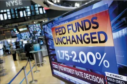  ?? RICHARD DREW — THE ASSOCIATED PRESS ?? A screen on the floor of the New York Stock Exchange shows the rate decision of the Federal Reserve. The Federal Reserve is leaving its benchmark interest rate unchanged while signaling further gradual rate hikes in the months ahead as long as the economy stays healthy.