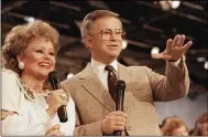  ?? ASSOCIATED PRESS FILE ?? Tammy Faye Bakker and her then-husband, television evangelist Jim Bakker, talk to their TV audience at their PTL ministry near Fort Mill, S.C., in 1986. She helped Jim build a multimilli­on-dollar evangelism empire and then saw it collapse in disgrace. She died July 20, 2007. She was 65.