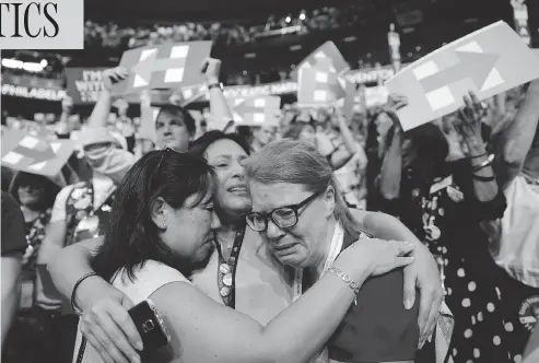  ?? JOHN LOCHER / THE ASSOCIATED PRESS ?? From left, delegates Carrie Pugh, Katrina Mendiola and Mayors Wegmann cry as Hillary Clinton was officially announced as the first woman to become the presidenti­al nominee of a major U.S. political party at the Democratic National Convention in...