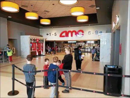  ?? DAN SOKIL — DIGITAL FIRST MEDIA ?? Moviegoers walk through the lobby area of the newly renovated AMC 309 Cinema 9 movie theater at Bethlehem Pike and Welsh Road in Montgomery Township on Friday afternoon.