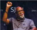  ?? ASSOCIATED PRESS FILE PHOTO, 2018 ?? John Carlos raises his fist as he speaks about his experience as an Olympian who participat­ed in the 1968Mexico City Games.