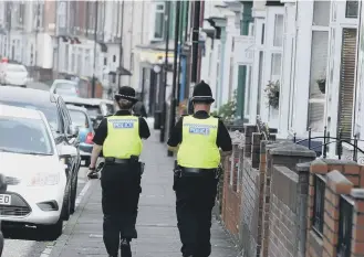  ??  ?? Police officers in Roker Avenue, Sunderland.