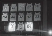  ??  ?? A spotlight shines on former Laker Kobe Bryant’s two jerseys as they are retired during a halftime ceremony in Los Angeles on Monday.