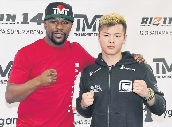  ??  ?? Floyd Mayweather, left, and Tenshin Nasukawa pose during a news conference in Las Vegas on Thursday.