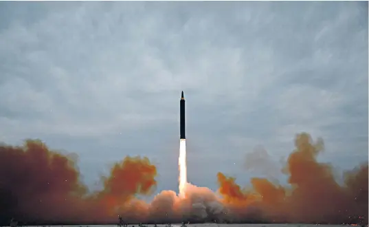  ??  ?? Left, an image purported by the North to be the missile’s launch; above, Kim Jong-un inspects the drill; right, Shinzo Abe, Japan’s prime minister; below, South Korean soldiers on exercises