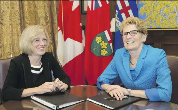  ?? GREG SOUTHAM ?? Alberta Premier Rachel Notley and her Ontario counterpar­t, Kathleen Wynne, pose for photos after signing a memorandum of understand­ing on energy and climate change initiative­s. Wildrose MLAs later criticized Wynne for her environmen­tal and fiscal...